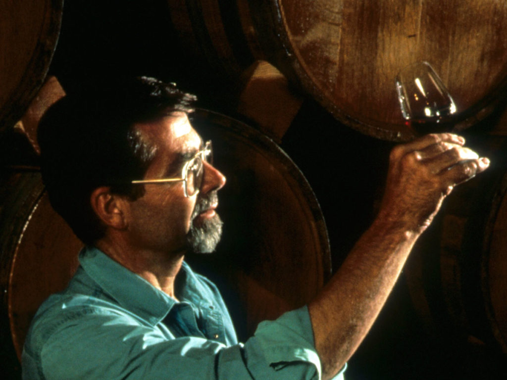 Paul Draper examines a glass of wine in the cellar.