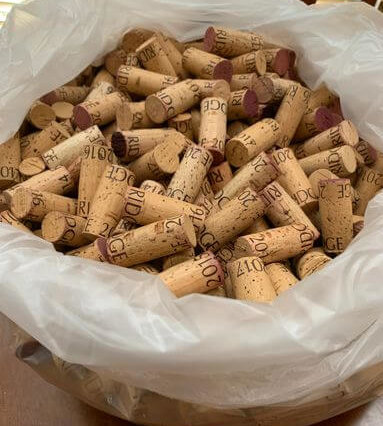 Bag of corks to be used for the DIY wine cork wreath project.